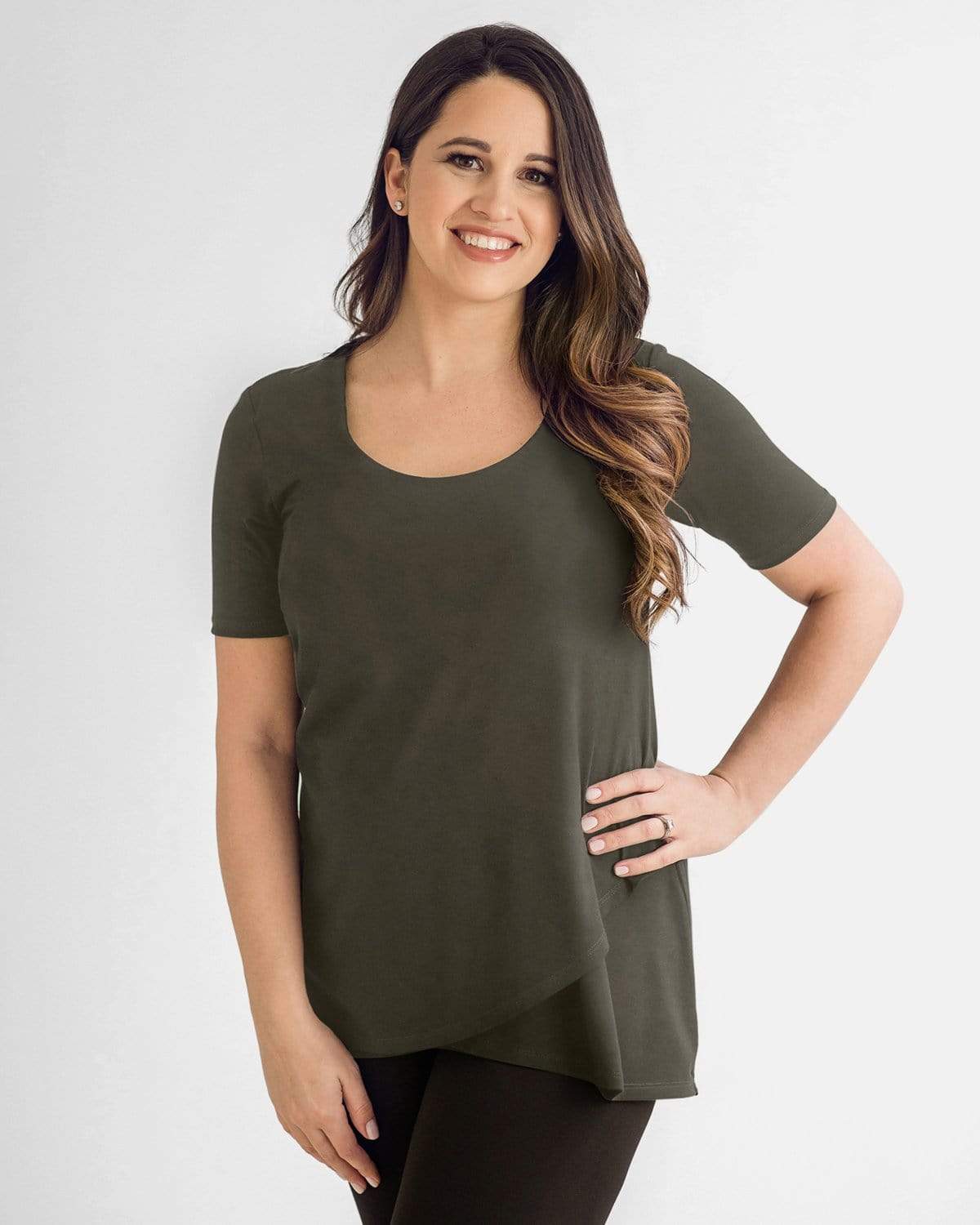 A woman wearing a olive, layered front nursing top with a scoop neck and short sleeves.