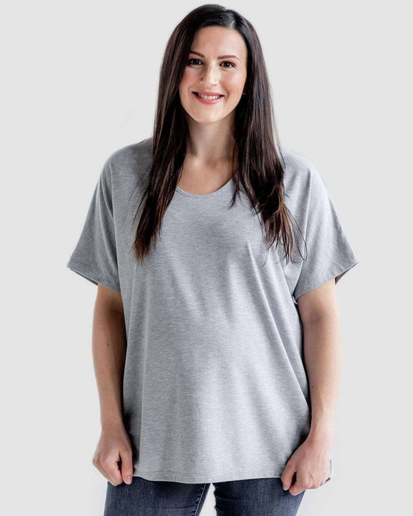 A pregnant woman wearing a gray Boardwalk Loose Maternity T Shirt with a relaxed fit and scoop V-neck.